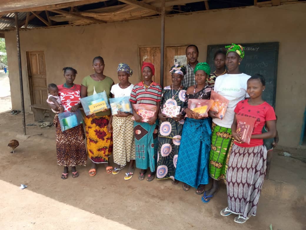 Community women with learning materials, Sierra Leone